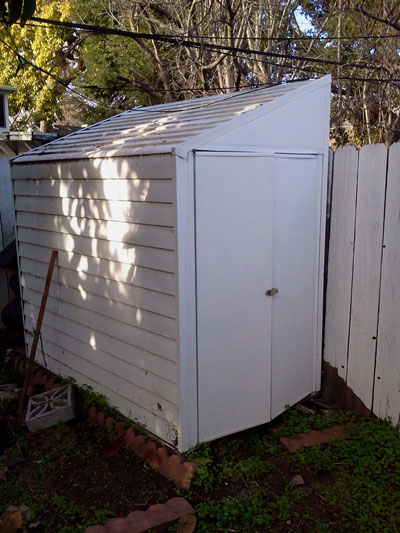 There is a small tool shed in the yard.