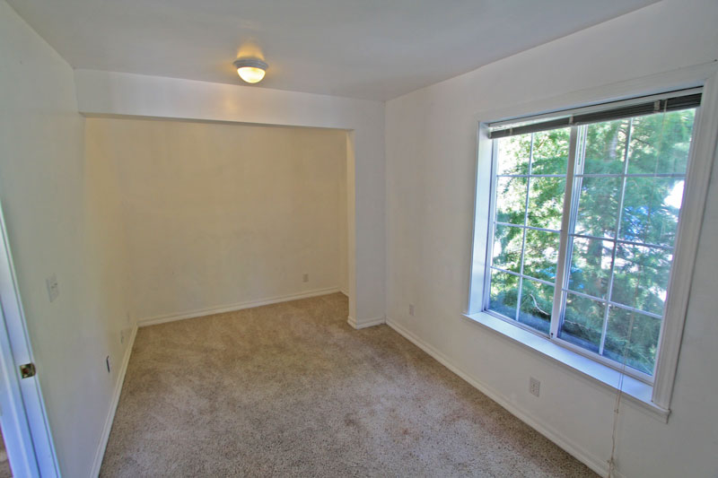 Bedroom with large window and alcove.