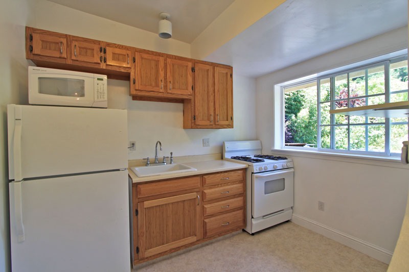 Kitchen with gas stove and custom cabinets.  Kitchen has a great view of the bamboo.