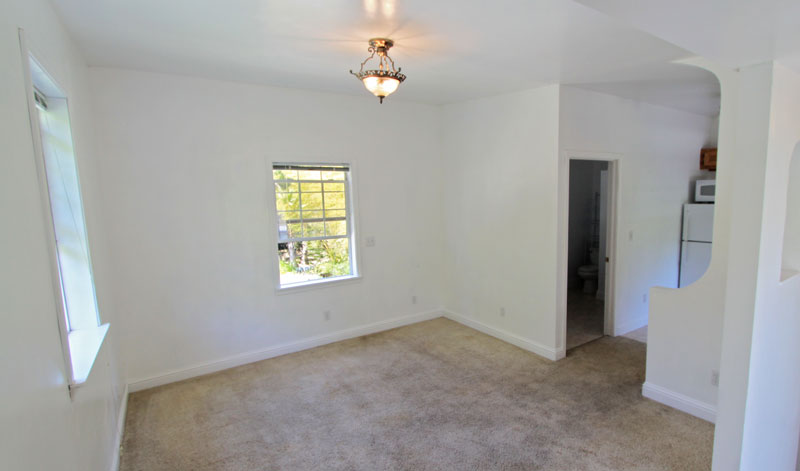 Another view of the upstairs room and kitchen beyond.